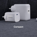 A compact white plug-in charger with a USB-C port and the 'stuftcool' logo, displayed in front of a larger matching charger on a dark gray textured fabric background. The word 'Compact' is printed in white text at the bottom.