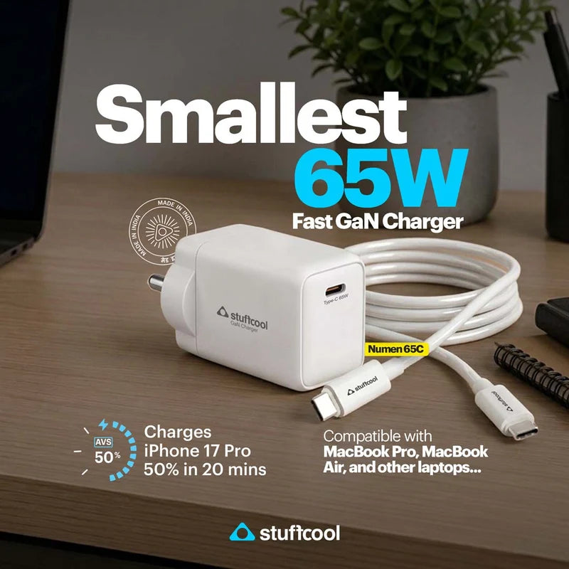 A white Stuffcool 65W fast GaN charger with a matching white USB-C cable on a wooden desk, surrounded by promotional text overlays and a blurred office background with a plant.