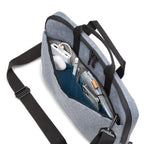 Gray crossbody bag with compartments containing electronic devices on a white background