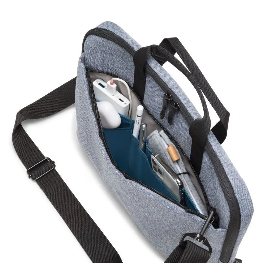 Gray crossbody bag with compartments containing electronic devices on a white background