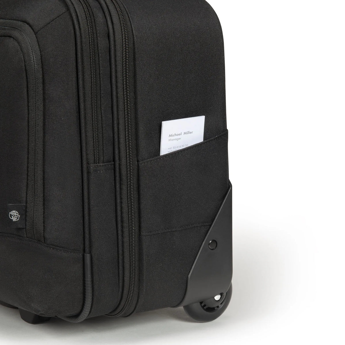 Black suitcase with a pocket containing a card on a white background