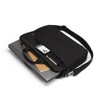 Black laptop bag with a phone and notebook inside on a white background