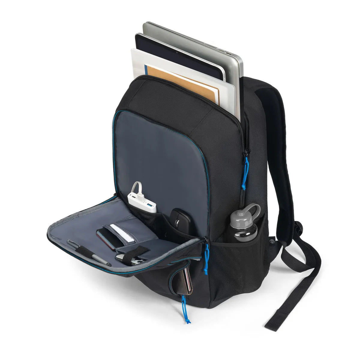 A black backpack shown open on a white background, filled with a laptop, notebooks, a water bottle, earbud case, and other accessories. The backpack has blue zipper pulls and a gray interior lining.