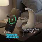 A curved white magnetic wireless charging stand on a wooden bedside table, shown charging a smartphone. The scene includes a lamp, glasses, and bedding in the background, with text overlays reading 'Precision Magnetic Alignment' and 'for seamless charging'.